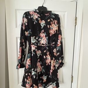 Woman’s black & floral wrap dress.